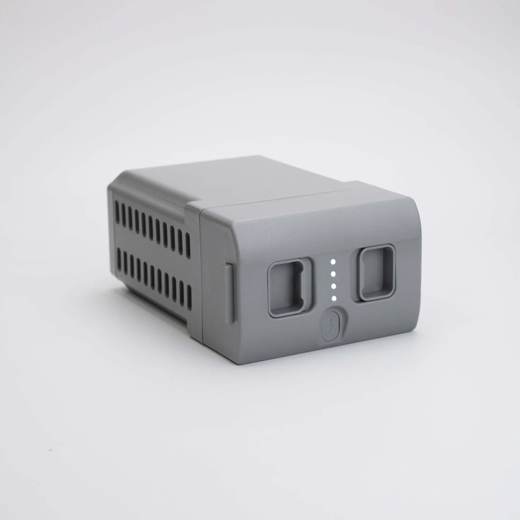 Unitree G1 battery side angle view showing the grey 9000mAh quick-release pack with ventilation slots, LED charge indicators and power button on a white background