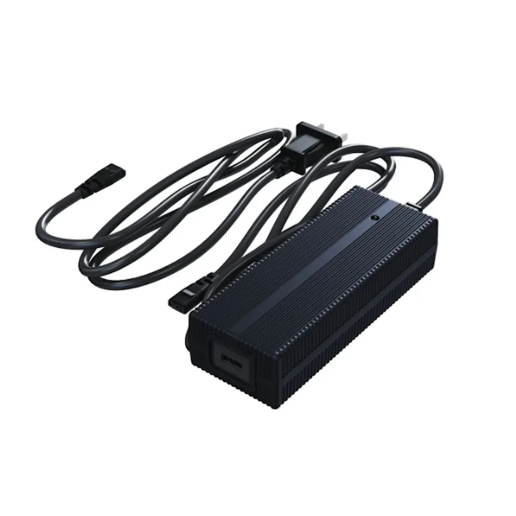 Unitree R1 battery charger three-quarter view with coiled AC and DC cables, showing the black finned casing and output port on a white background